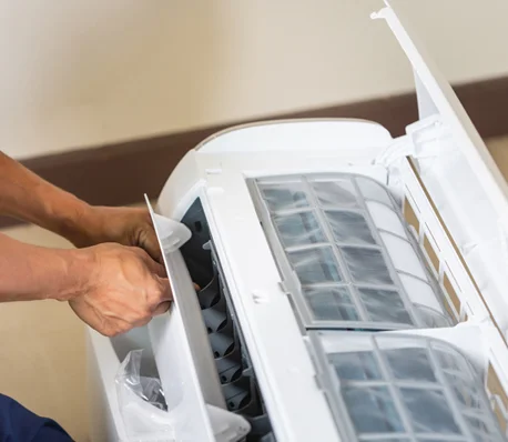 Technician working on AC unit