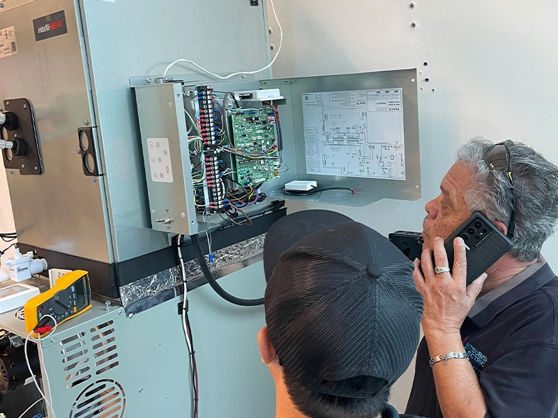 Technicians working on a HVAC unit.
