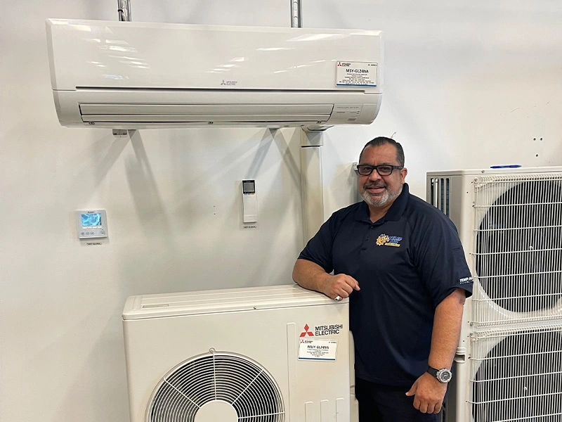 Technician with Mitsubishi HVAC units.